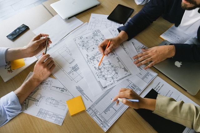 Team discussing the Product Requirements Document (PRD) for a custom PCBA and hardware development project