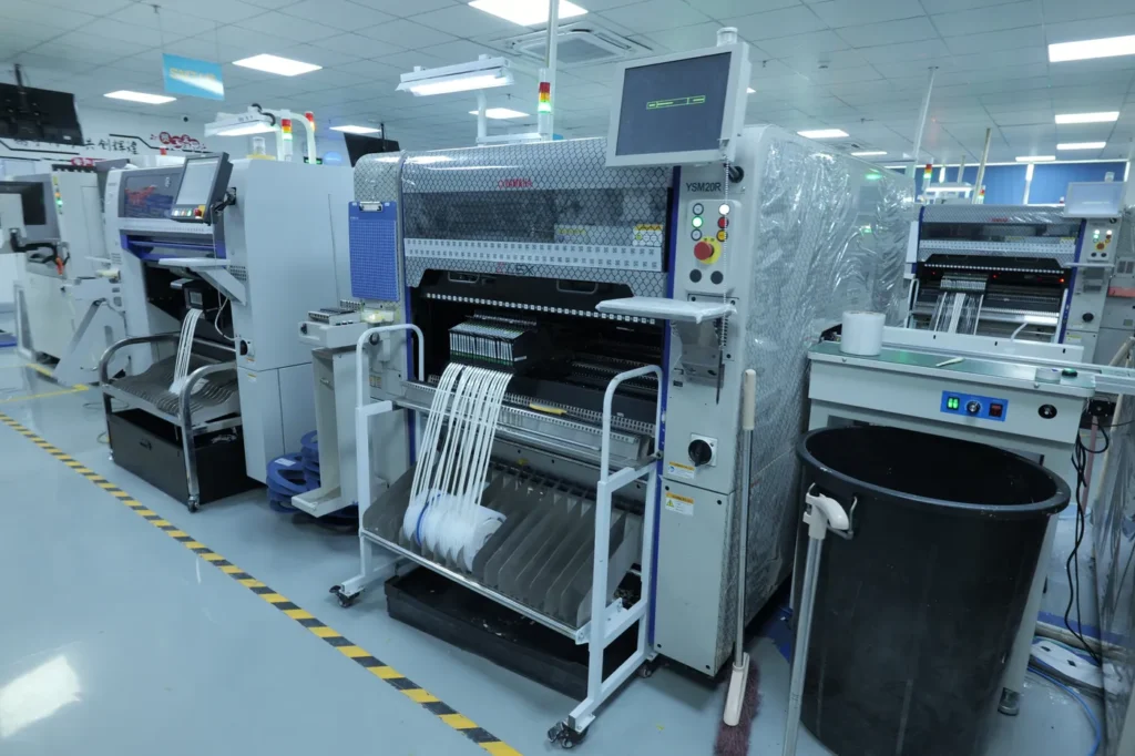 YSM20R surface mount machine in an SMT workshop, supporting 0201mm to 55x100mm components with a wide-scan camera and 140 feeder slots